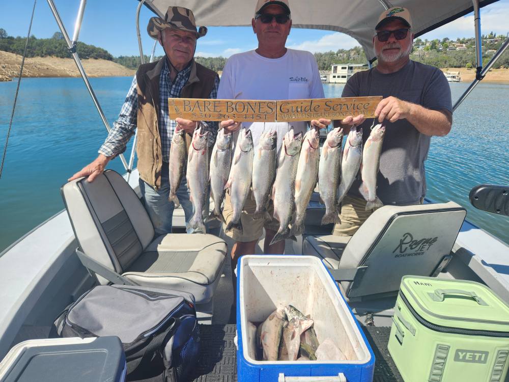 Brett Brady clients holding a strong salmon and trout catch